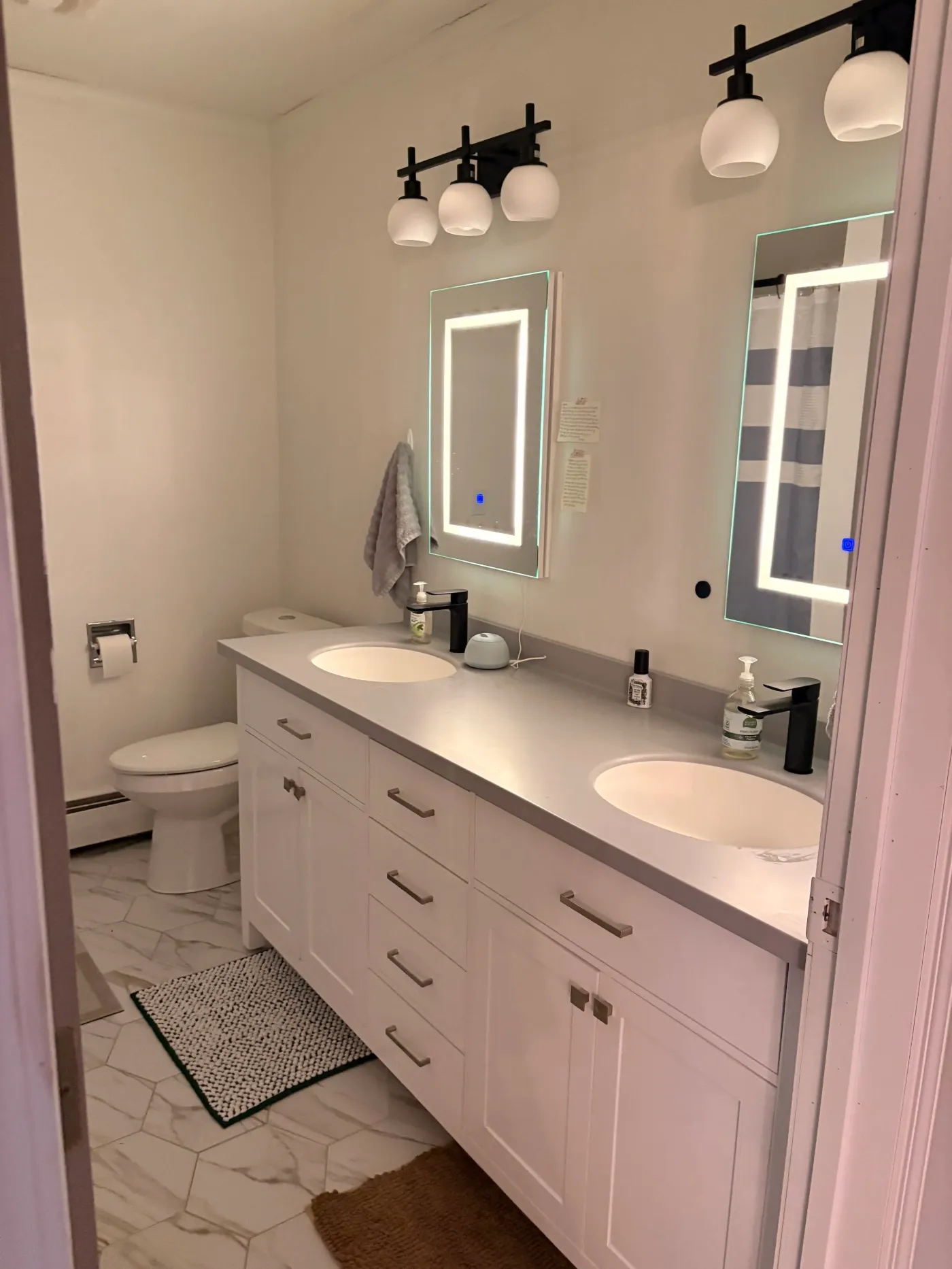 Modern bathroom with lighted mirrors