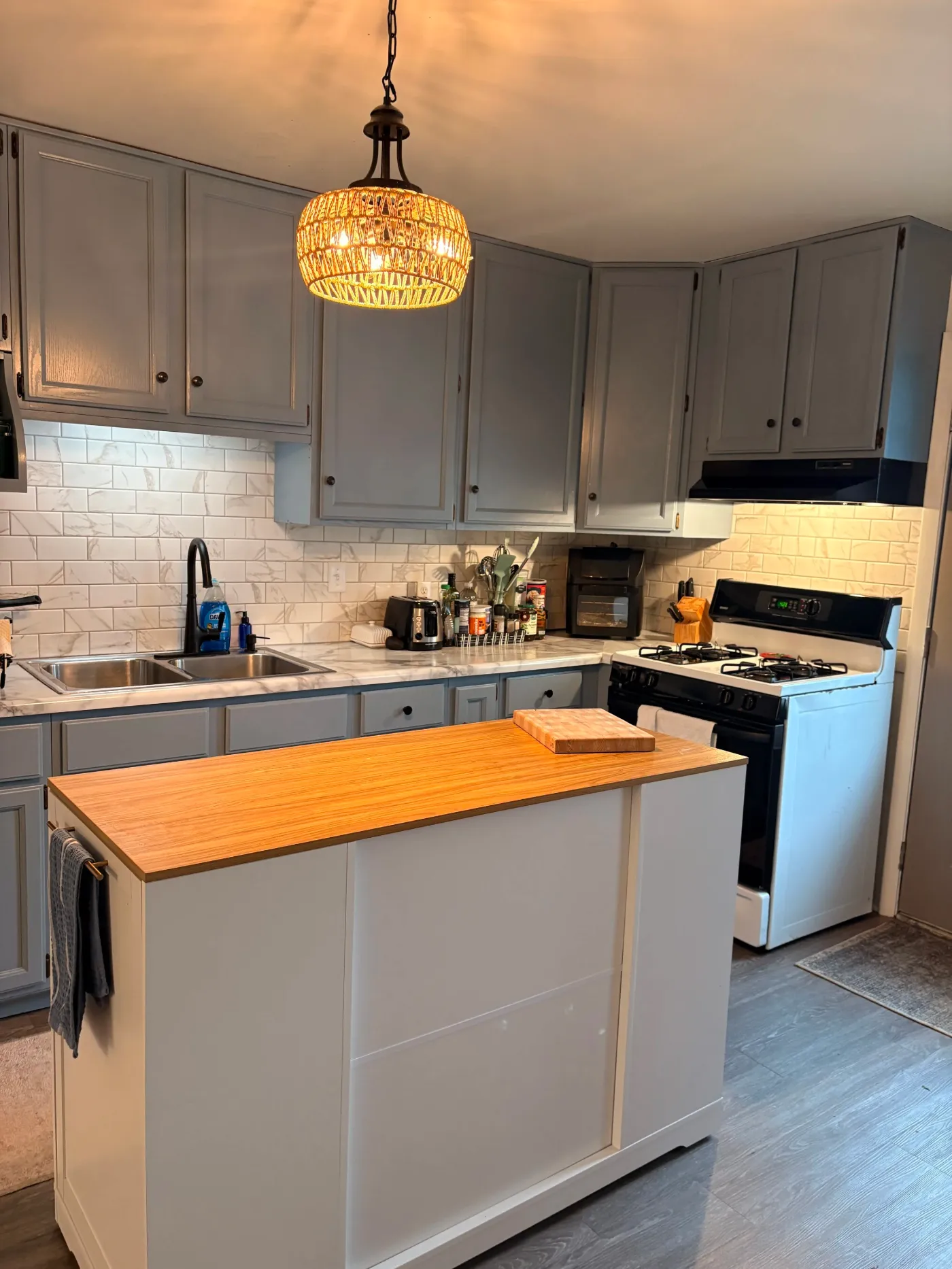 Updated kitchen with island at Casa Nova, an Allendale co-living home